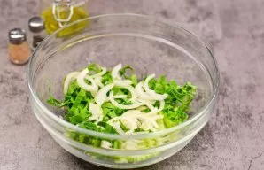 Transfer the cabbage to a salad bowl. Cut the onion into half rings and add to the salad.