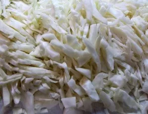 During this time, wash the cabbage and carrot. Drain and chop the cabbage, and peel and grate the carrot.
