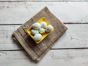 Boil quail eggs, cool them and peel them.