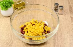 Then add canned corn to the beans.