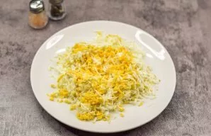 Grate the eggs on a fine grater.