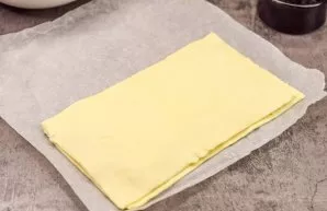 Cover the cheese with the second half of the dough and roll it out a little with a rolling pin so that the layers merge with each other a...