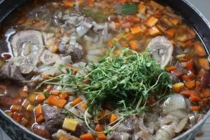 Boil for a few minutes, add bay leaf, pour water and add thyme. When the soup boils, reduce the heat to medium, remove the sediment, cove...
