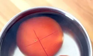 Chop the tomatoes and pour boiling water, transfer to cold water after a minute. Then peel off the skin.