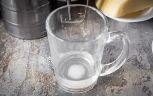 In a glass of warm water, mix salt and sugar and pour this mixture into a bowl with flour and yeast.