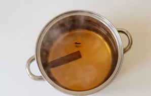 Add cinnamon, cloves and sugar. Reduce heat and simmer for 5 minutes.