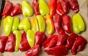Line the baking sheet with baking paper. Arrange the peppers with the skin upwards in one row, at a short distance from each other. Send ...