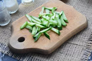 Cut fresh cucumbers into strips.