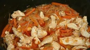 Then add carrots, chicken cut into medium pieces, cumin, salt, bell pepper and pepper to the onion. Cook the ingredients together, stirri...