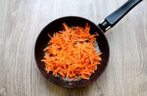 While the chicken is boiling, peel the carrots and onions. Put butter in a pan and melt over medium heat. Grate the carrots on a coarse o...