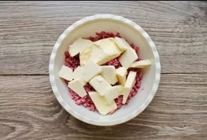 Add softened butter to the bowl with the sausage.