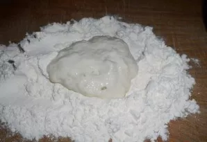 Put the remaining flour on the table and put the dough on it with a spoon.