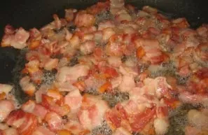 Finely chop the bacon, fry in vegetable oil.