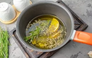 Put 1-2 sprigs of rosemary, 2 large cloves of garlic (cut into halves), Provencal herbs (optional, but they make it more aromatic), lemon...