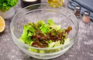 Tear the clean, dry lettuce leaves into a deep bowl.