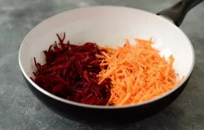 Add tomato paste, fry a little with onions. Then add finely chopped beets and carrots. Stirring constantly, fry for a couple of minutes. ...