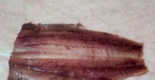 Unwrap the carcass, removing the spine and bones, and place it on top of the cling film.