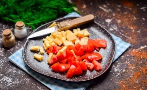 Cut the hard cheese into small cubes. Add salty to the tomatoes.