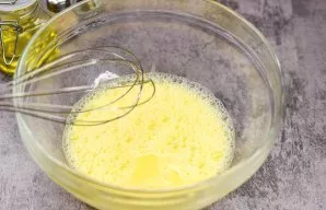 In a deep bowl, beat the egg and three tablespoons of water with a blender.