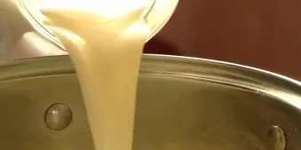 Put the pot on the fire, add milk. Stirring constantly, cook the cream until thickened.