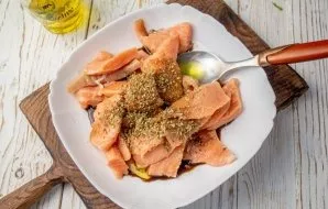 Add olive oil, soy sauce, honey, dried oregano and ground black pepper to the fish.