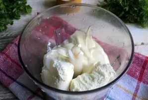 Add the cottage cheese to the blender bowl and sow the sour cream. The amount depends on the desired consistency of the application.