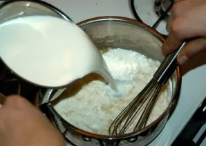 Fry the flour a little until golden brown. Meanwhile, heat the milk without bringing to a boil. Pour in a thin stream and mix well so tha...