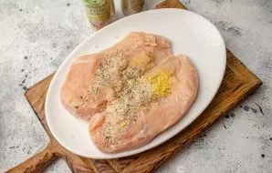 Sprinkle one and the other side of the chicken breast with spices.