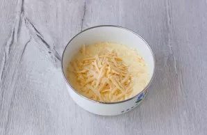 Grate the cheese and add it to the eggs. Mix it up.