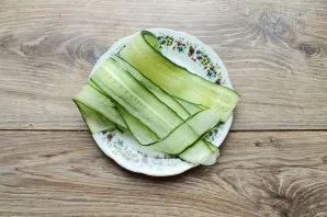 Cut the cucumber lengthwise into thin strips.
