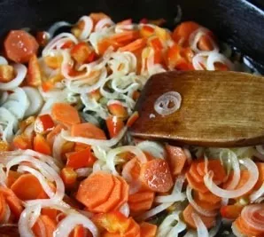 Melt the butter in a pan, throw all the vegetables into it, except garlic and herbs.