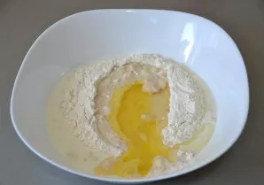 Pour in the butter and add the beaten egg.