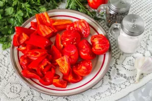 Wash the tomatoes and peppers, remove the seeds from the pepper by cutting off the caps. Cut the tomatoes in half and cut out the green c...