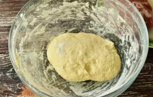 Knead the dough. Cover the bowl with a towel and put in a warm place for an hour.