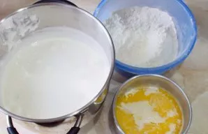 Sift flour and soda through a sieve and gradually pour into the egg mass, alternating with hot milk. Mix everything by hand so that the m...