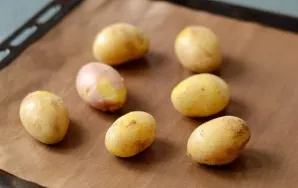 Preheat oven to 220 degrees. Put the potatoes in the oven and bake for 2-3 minutes. Then remove the potatoes from the oven and let them c...