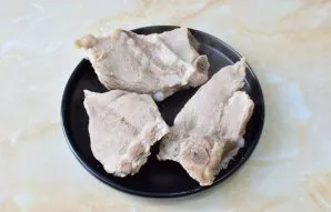 Boil the meat with bones for 1-1.5 hours in boiling water. Then separate the meat from the bones and strain the broth.