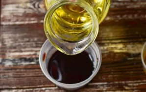 Pour vegetable oil into soy sauce.