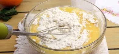Mix flour with baking powder, gradually add to the resulting egg-butter mixture. The dough will be quite light and liquid.