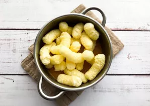 Remove the mixture from the heat, add corn sticks and mix well.