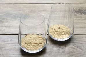 Grind cookies in any convenient way and put in glasses.