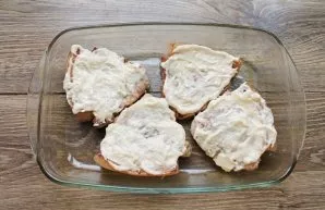 Mix mayonnaise with prepared horseradish and chopped garlic. Transfer the cooked meat to a baking dish and spread the mixture on top.