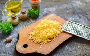 Grate the hard cheese with a fine grater.