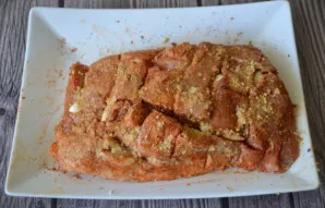 Coat the ham with mustard and salt.