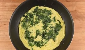 Meanwhile, heat the olive oil in a pan. Put onions and spinach in it. Bake for 2 minutes. Then add butter and beaten eggs. After 3 minute...