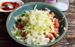 Add finely chopped onion and garlic.