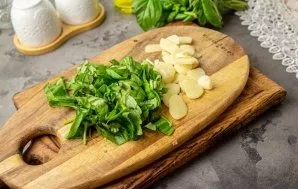 While the peppers are baking, wash and dry the basil, cut into thin strips. Peel the garlic and cut into thin plates. The amount of basil...
