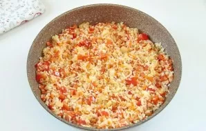 Add the washed rice and continue to fry everything together until the rice is transparent.