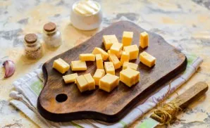 Cut the hard cheese into small cubes or strips.