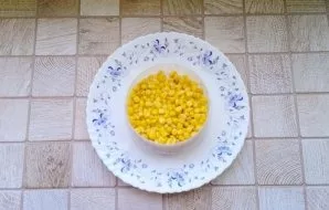 Canned corn will be the second layer of salad.